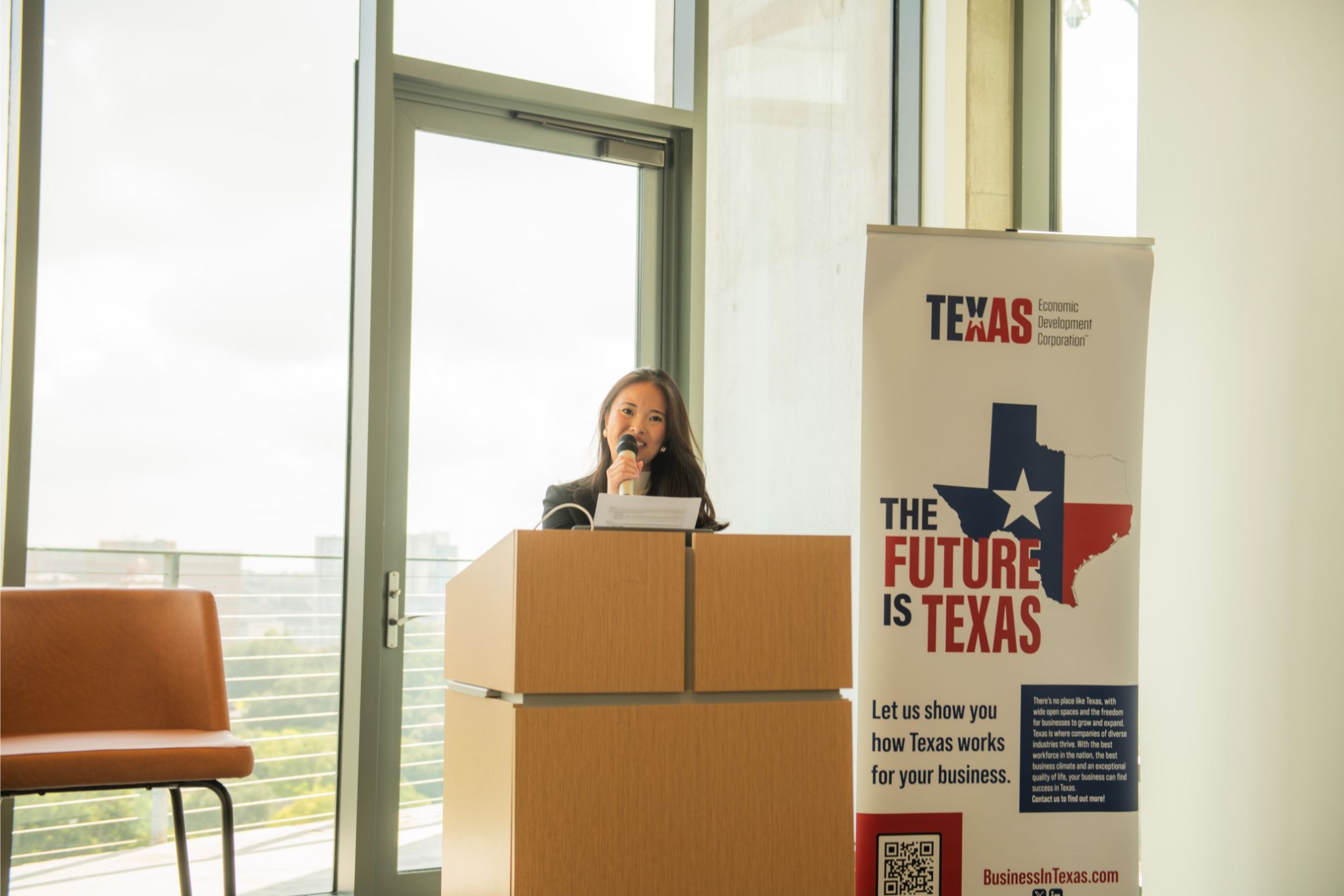 Milea Amanai of American Katerra moderating at the podium during The Road Ahead, hosted by TxEDC in Austin on July 24, 2026